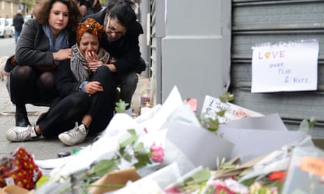 A woman cries near Le Petit Cambodge restaurant in Paris