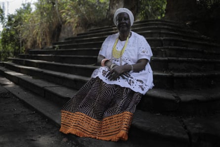 A woman sits on steps.