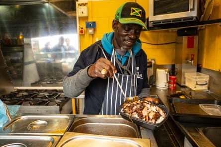 Carlton Hunter cooks at the Shak, his family’s Jamaican street food outlet at Tooting and Mitcham Football Club.
