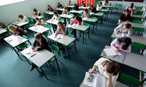 A classroom of teenage girls taking an exam.