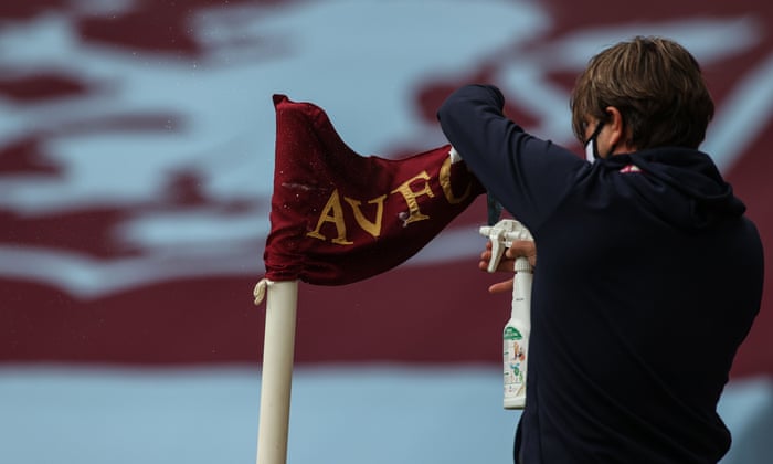 A staff member disinfects a corner flag prior to the English Premier League football match between Aston Villa and Sheffield United at Villa Park.