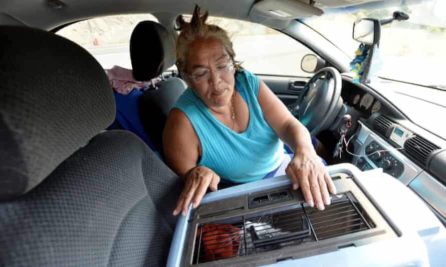 Martha Van Dyke of Lytton sits in her car with her cat, Kona, after a wildfire raged through her town.