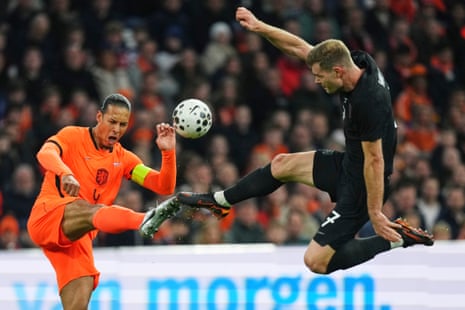 Virgil van Dijk and Alex Sørloth contest the ball.