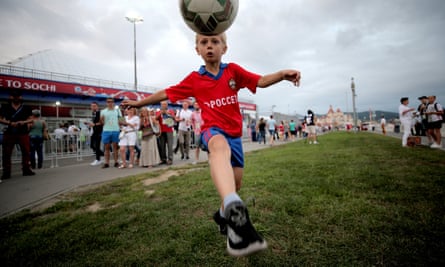 A young Russian fan juggles a ball as fans arrive for the semi-final between Germany and Mexico.