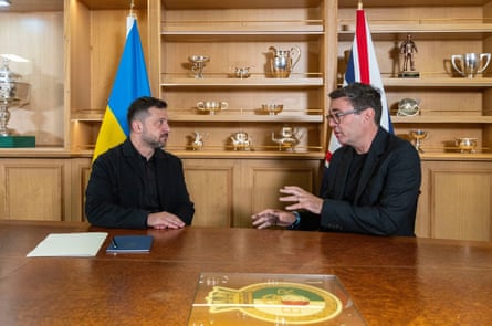 Volodymyr Zelenskyy talks to Andy Burnham at the naval base in Portsmouth, England.