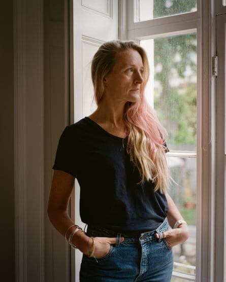 Catherine Milne, photographed at home in London last month. She is pictured wearing a dark T-shirt and jeans standing by a window