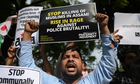 A protester holds a placard reading ‘Stop killing of Muslims in Assam – Rise in rage against police brutality!’