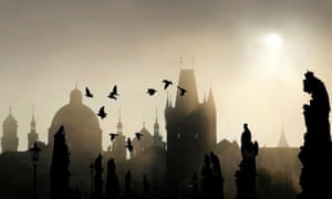 Sun rises over the medieval Charles Bridge in Prague.