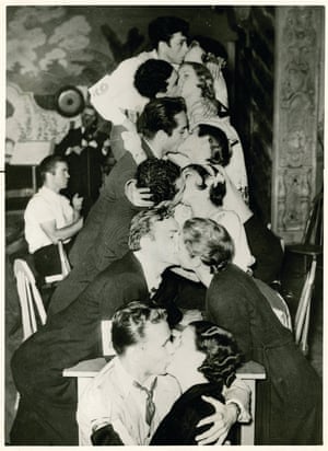 A vintage  found photograph of a row of couples kissing taken from the book People Kissing: A Century of Photographs by Barbara Levine and Paige Ramey.