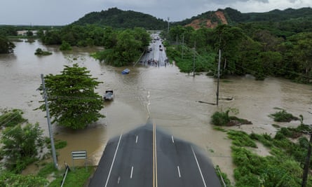 Bridge flooded by water and green trees