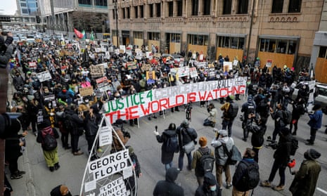 Demonstrators march in Minneapolis after the closing statements in the trial of former police officer Derek Chauvin over the death of George Floyd.