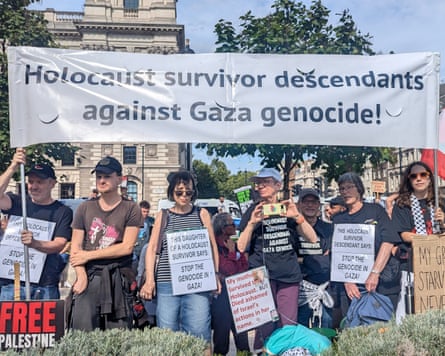 A line of people holding a banner reading âHolocaust survivor descendants against Gaza genocideâ