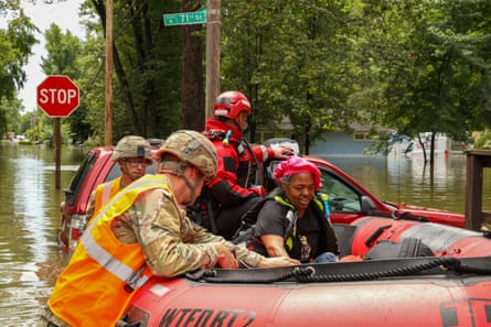 First responders helping a resident in flood waters in Indianapolis, Indiana, on 15 August 2026.
