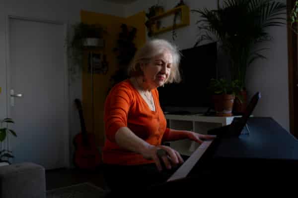 Liudmyla Abdo plays piano at the Paris apartment she now shares with her son, Marsel.