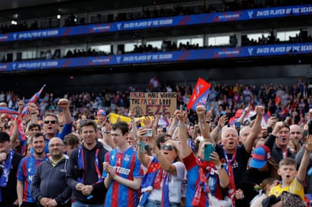 Palace fans cheer during the FA Cup winning party on the pitch at Selhurst Park.