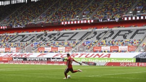 Duesseldorf’s goalkeeper Florian Kastenmeier kicks the ball in front of empty stands.