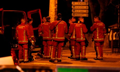 Firefighters stand near Notre-Dame Cathedral in Paris.