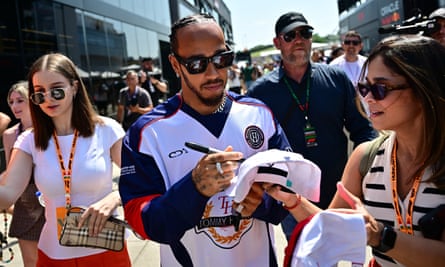 Lewis Hamilton signs autographs for fans at the Hungaroring