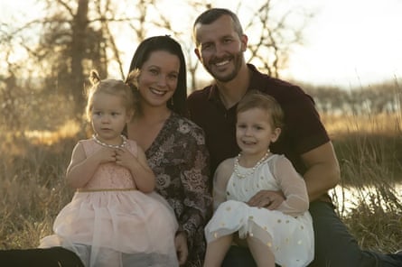 A wholesome looking family pose together at sunset.