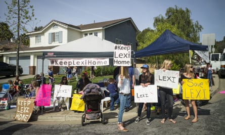 Supporters of Lexi’s foster family hold a rally for the family outside her foster home in Santa Clarita, California, on Monday.