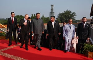 The leaders on a red carpet at the top of some steps