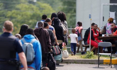 A group of asylum seekers waits to be processed at the Canadian border.