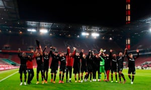 Bayer Leverkusen players salute an empty away end after winning 4-0 at local rivals Cologne.