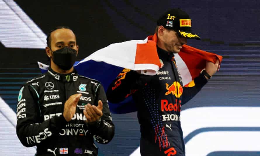 Red Bull’s Max Verstappen celebrates winning the world championship as Mercedes’ Lewis Hamilton applauds.