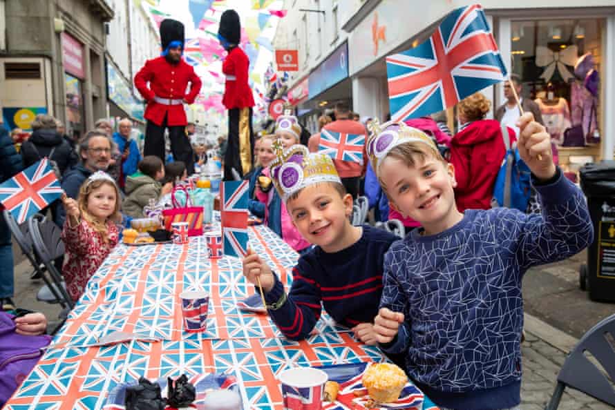 Charlie (blue and white sweater) and Jenson (blue and red sweater) enjoy a street party in Falmouth.