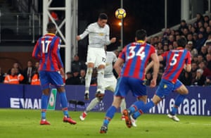 Chris Smalling heads one back for United.