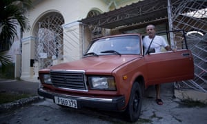 Havana resident Leandro Cueto poses for a portrait with his Lada