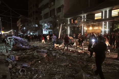 Palestinians inspect the site of an Israeli airstrike in Gaza City on Tuesday.