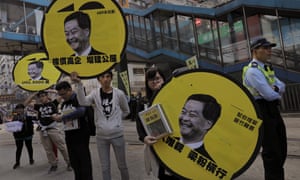 Protesters raise pictures of Hong Kong’s chief executive Leung, Chun-ying
