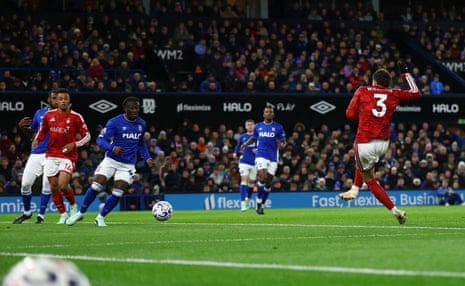 Neco Williams, in red, strikes the ball to score as Ipswich players look on