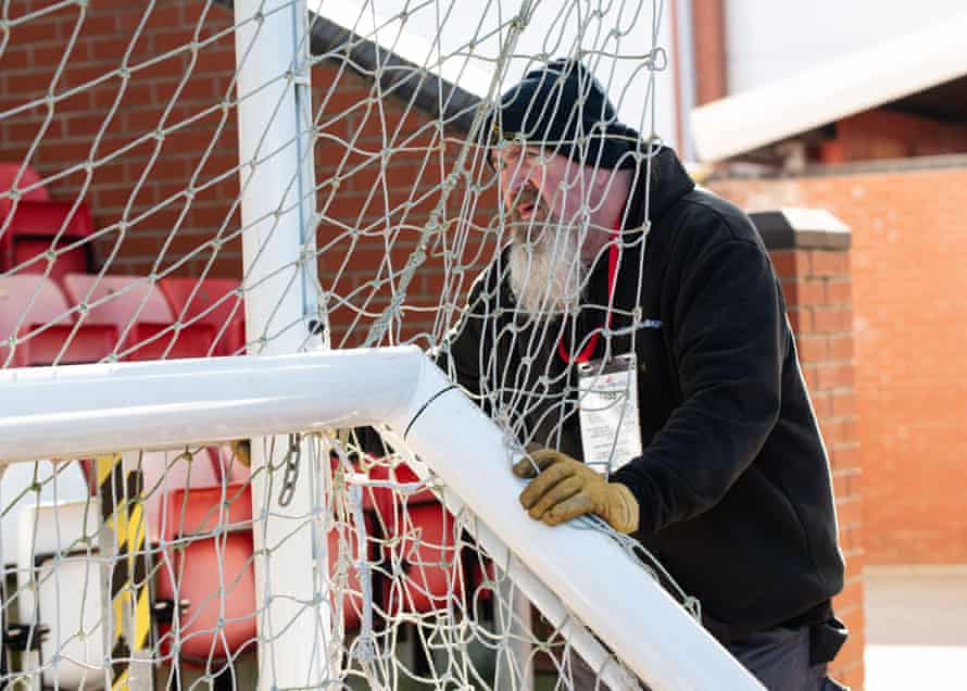 Ground staff adjust the nets.