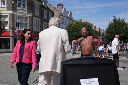 Fard and Erlam speak with residents on a sunny street
