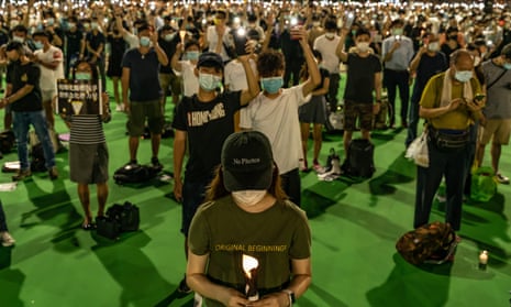 Participants hold candles as they take part in a memorial vigil in Victoria Park, Hong Kong,to mark the anniversary of the 1989 Tiananmen Square massacre.