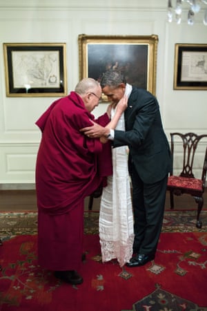 President Barack Obama receives a white khata, a silk Tibetan scarf, from the Dalai Lama following their 2014 White House meeting.