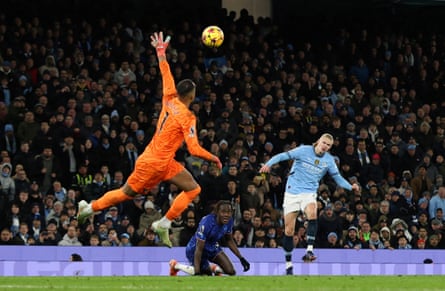 Erling Haaland lobs Chelsea’s Robert Sánchez last season.
