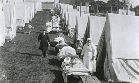 Medical staff care for people with influenza at an emergency tent hospital in Brookline, Massachusetts, in October 1918.