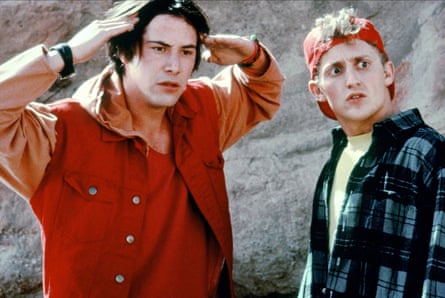Actors Keanu Reeves, in a red jacket with his arms raised, and Alex Winter, wearing a plaid jacket and a bandana round his head, in a scene from Bill & Ted’S Bogus Journey Actors Keanu Reeves, in a red jacket with his arms raised, and Alex Winter, wearing a plaid jacket and a bandana round his head, in a scene from Bill & Ted’S Bogus Journey