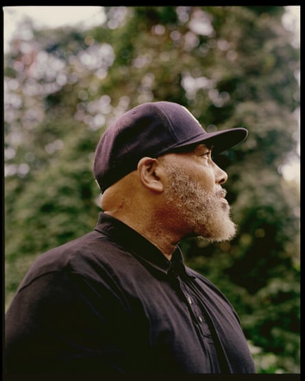 Portrait of Alprentice Davis looking away from the camera, with trees in the background.
