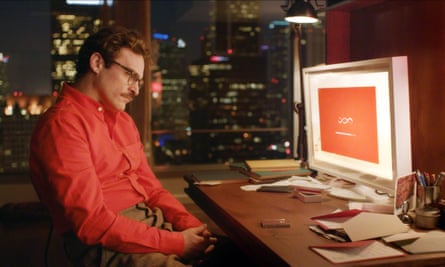Joaquin Phoenix as Theodore in Her, sitting in front of a computer screen.