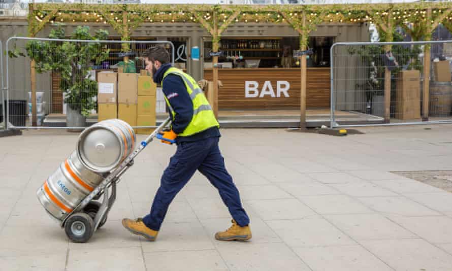 An outdoor bar stocks up with beer in time for reopening.