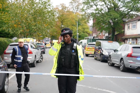 A police officer on duty at the cordon near the scene.