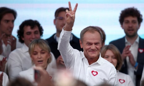 Supporters and leaders of the largest opposition grouping, Civic Coalition (KO), react to exit polls, with its leader, Donald Tusk