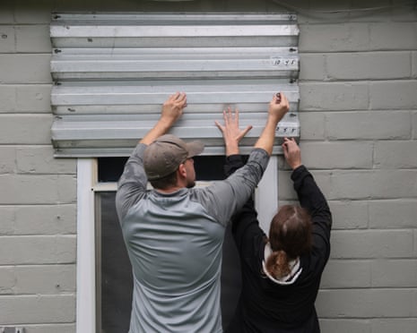 Dan Conley and Suzanna Buchanan put up shutters before the arrival of Hurricane Isaias in Pensacola, Florida.