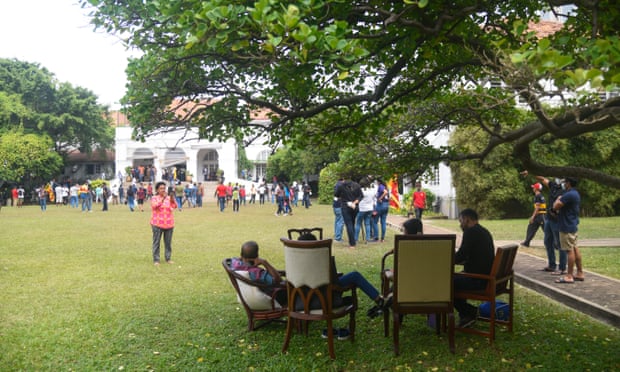People occupy the garden and grounds of Temple Trees.