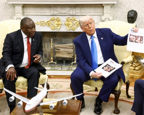 Trump and Ramphosa in the Oval Office, with Trump holding printed news articles