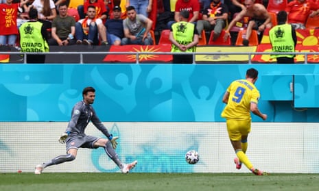 Roman Yaremchuk scores Ukraine’s second goal as North Macedonia supporters watch on.